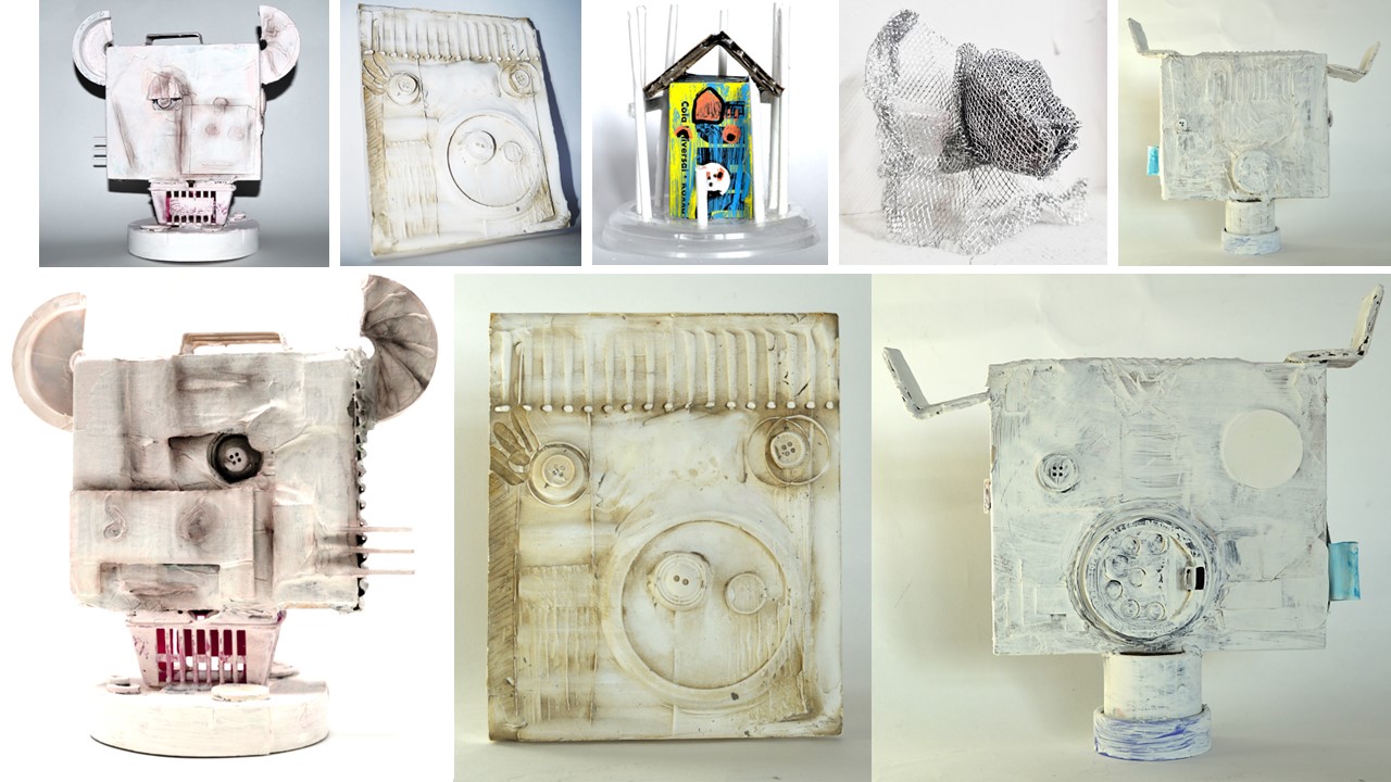 Collection of student-made sculptures and reliefs using recycled materials and white paint.