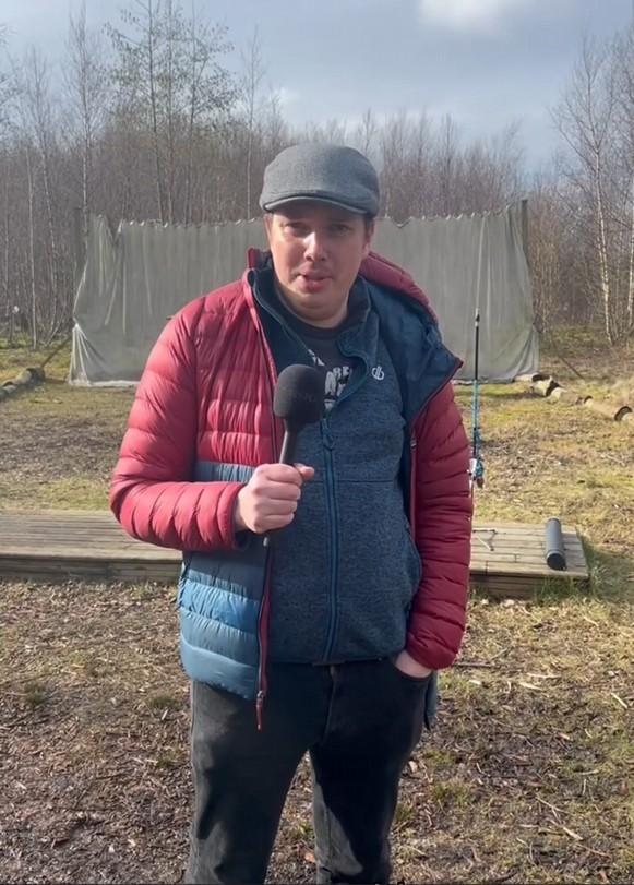 HN Adventure Sports student Steven speaking into a microphone during an outdoor activity session.