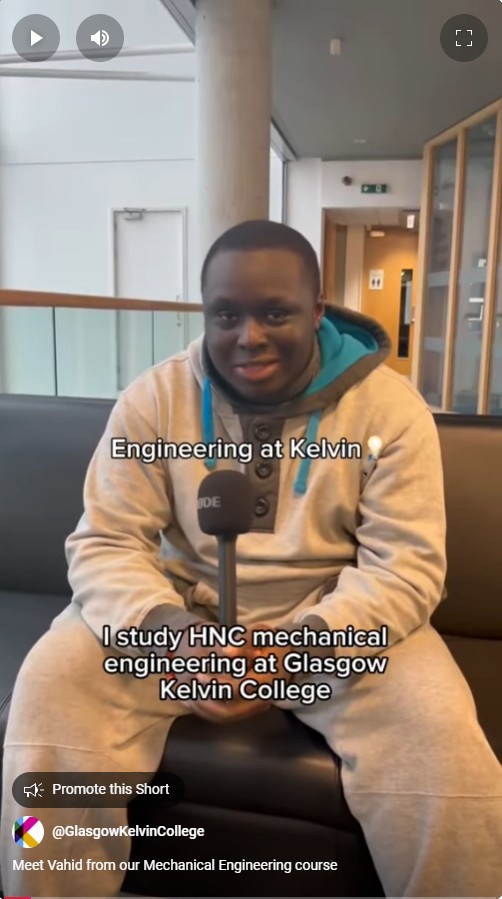 A student in a grey and teal hoodie sitting on a black sofa, holding a microphone and smiling. The text overlay reads 'Engineering at Kelvin 💡' with the student introducing themselves as studying HNC Mechanical Engineering at Glasgow Kelvin College.