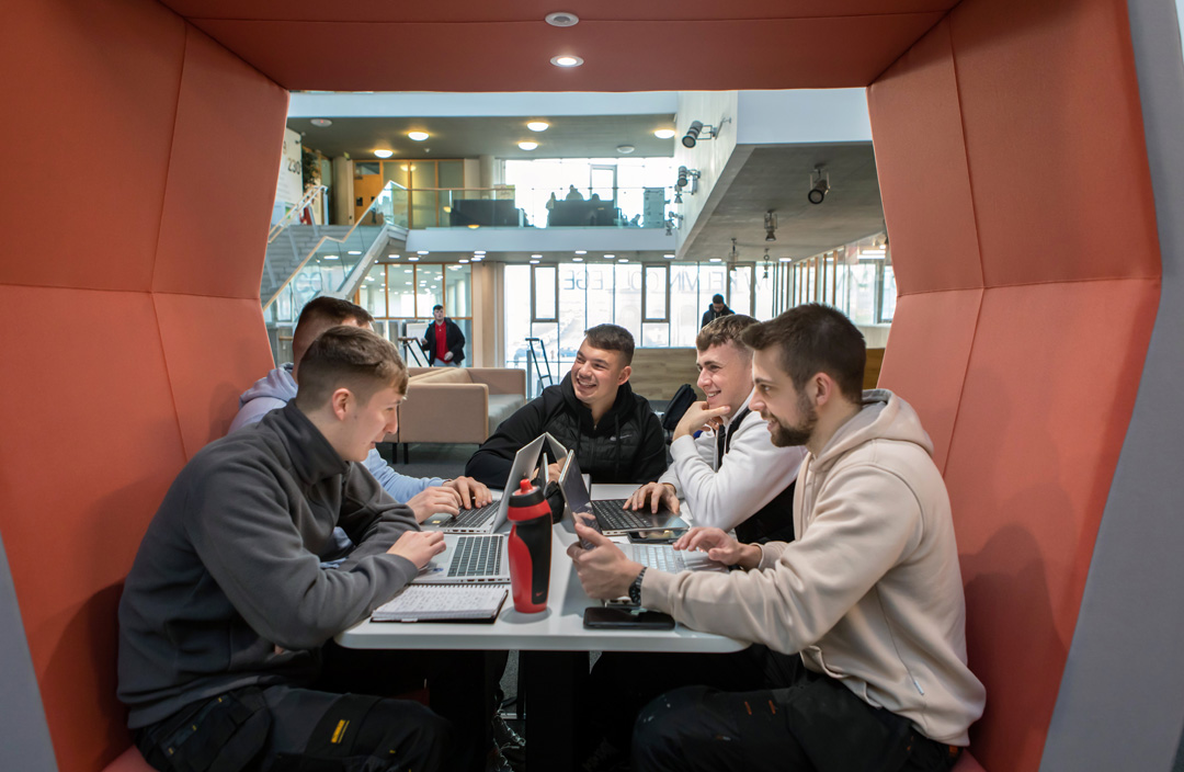 Group of students working together on laptops in a study pod at Glasgow Kelvin College’s Springburn campus.