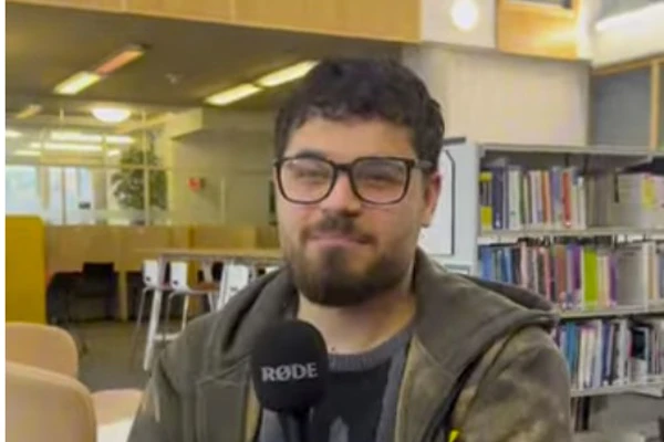 Muhammed, an HNC Applied Science student at Glasgow Kelvin College, speaks into a microphone while seated in the library, sharing his study experience. Muhammed, an HNC Applied Science student at Glasgow Kelvin College, speaks into a microphone while seated in the library, sharing his study experience.