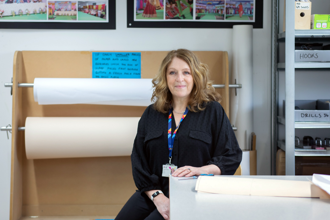 Fashion lecturer in a pattern cutting and garment construction workspace at Glasgow Kelvin College.