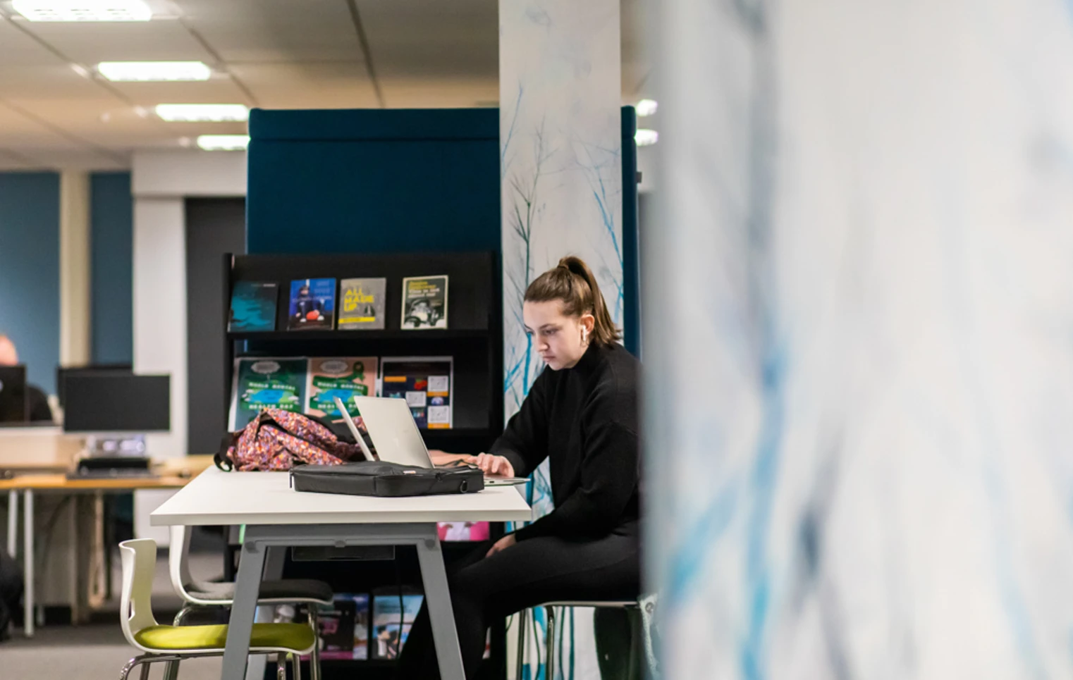 Student working on a laptop at a study desk in the Library and Flexible Learning Centre at Glasgow Kelvin College’s Easterhouse Campus, with bookshelves and resources in the background. Student working on a laptop at a study desk in the Library and Flexible Learning Centre at Glasgow Kelvin College’s Easterhouse Campus, with bookshelves and resources in the background.