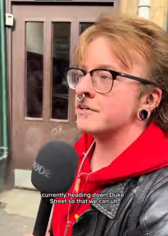 Joshua, HND Art & Design student, speaking into a microphone during a street interview in Glasgow.