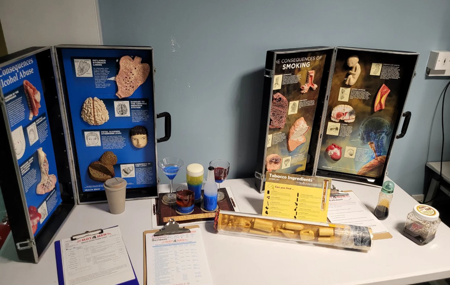 Educational display table at Glasgow Kelvin College showing the health consequences of alcohol abuse and smoking, with anatomical models, charts, and information leaflets. Educational display table at Glasgow Kelvin College showing the health consequences of alcohol abuse and smoking, with anatomical models, charts, and information leaflets.