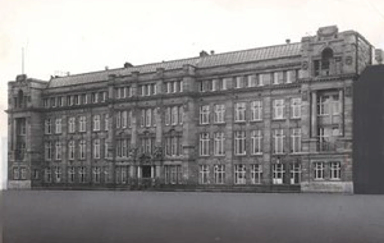 Black and white photograph of the original North Glasgow College building, showcasing its grand early 20th-century architectural style with ornate stonework and large sash windows. Black and white photograph of the original North Glasgow College building, showcasing its grand early 20th-century architectural style with ornate stonework and large sash windows.